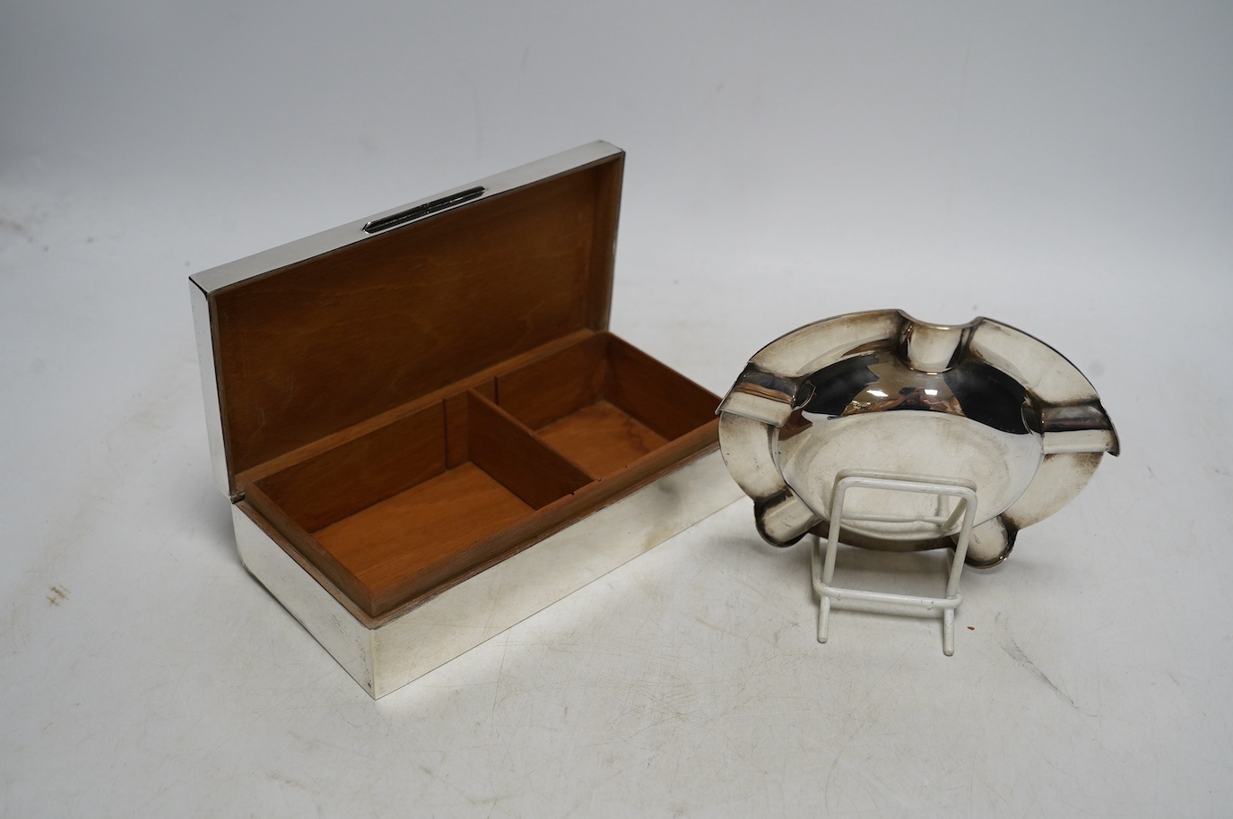 A 1960's engine-turned silver mounted rectangular cigarette box, 17.8cm and a silver ashtray. Condition - fair